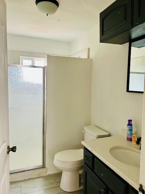 2804 Vanda Avenue Lubbock, TX 79404 - Photo 5 of 5 a bathroom with a granite countertop sink toilet and a mirror
