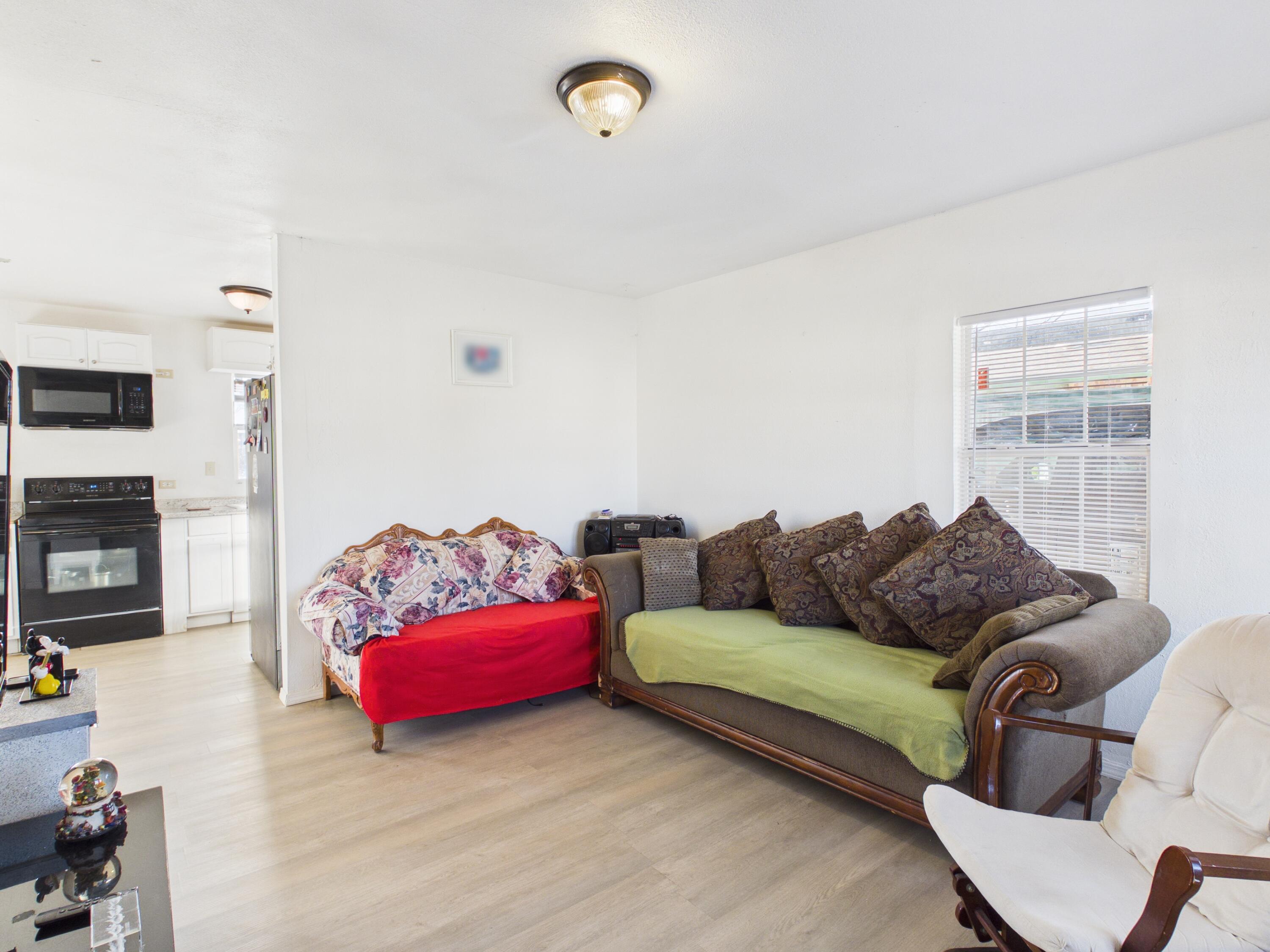 2804 Vanda Avenue Lubbock, TX 79404 - Photo 6 of 23 a living room with furniture a fireplace and a flat screen tv