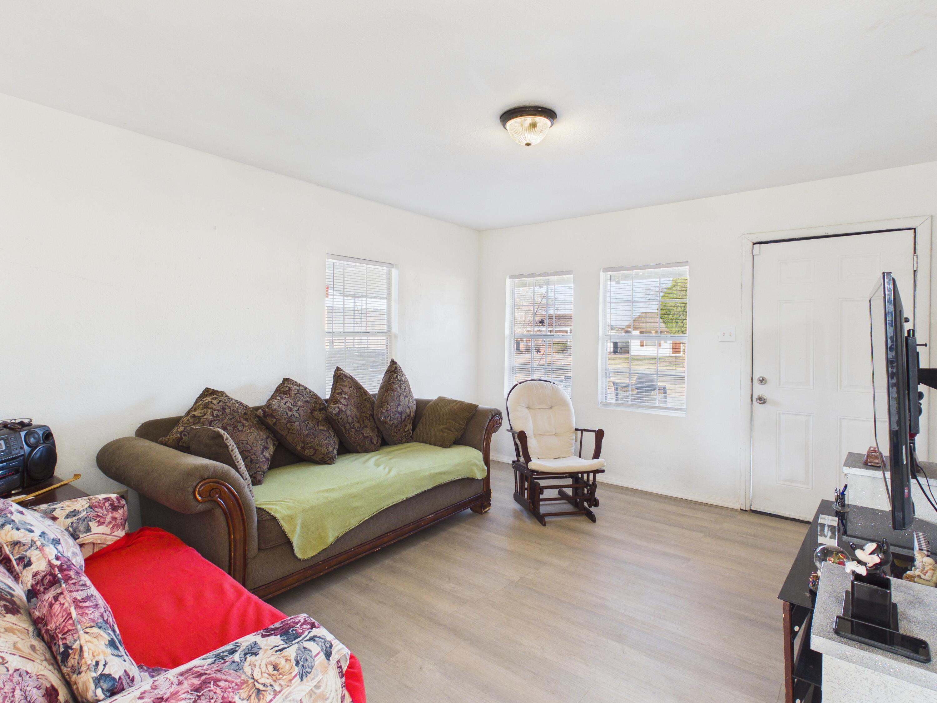 2804 Vanda Avenue Lubbock, TX 79404 - Photo 7 of 23 a living room with furniture and a flat screen tv