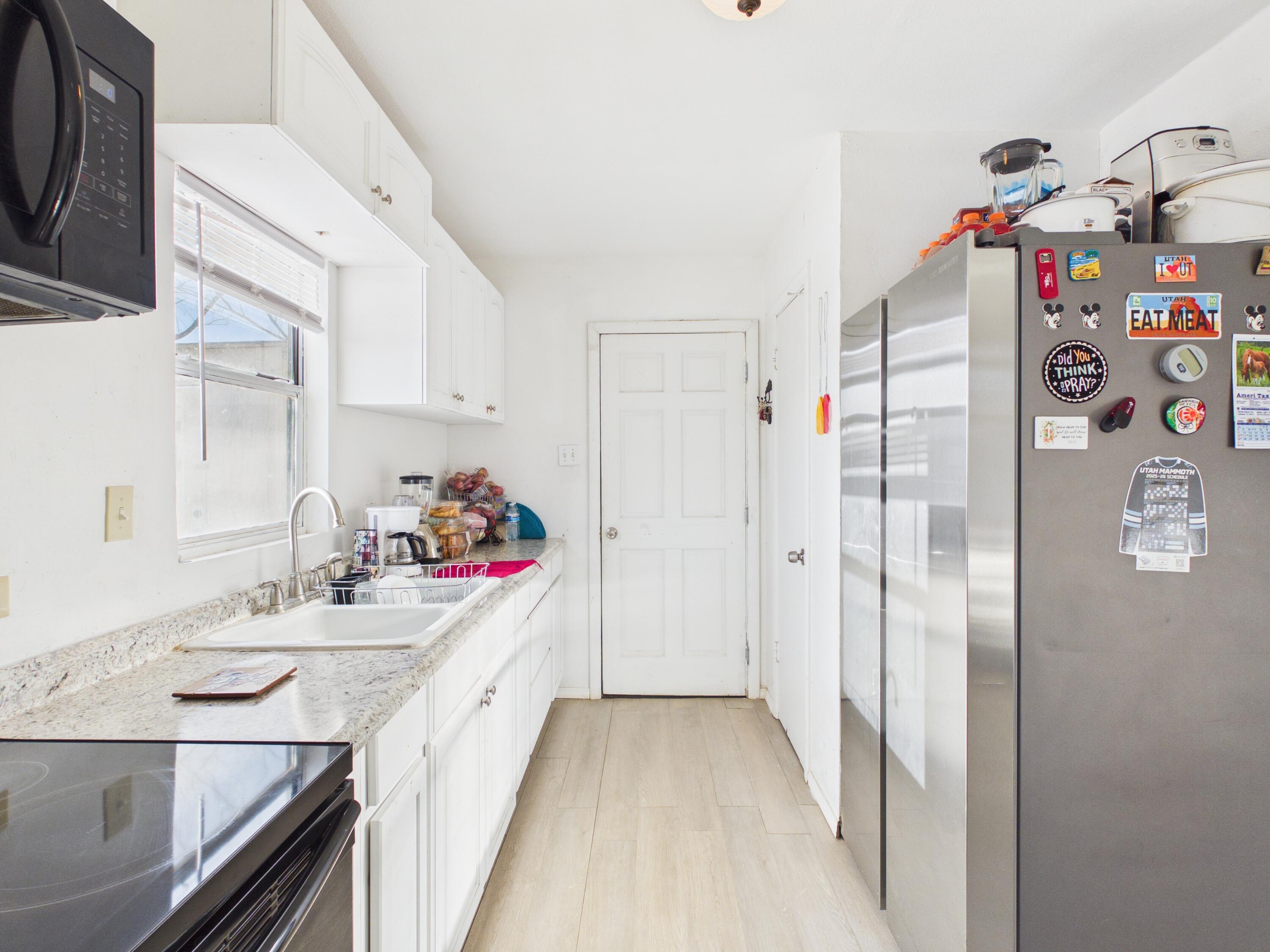 2804 Vanda Avenue Lubbock, TX 79404 - Photo 9 of 23 a kitchen with granite countertop a white refrigerator and a sink