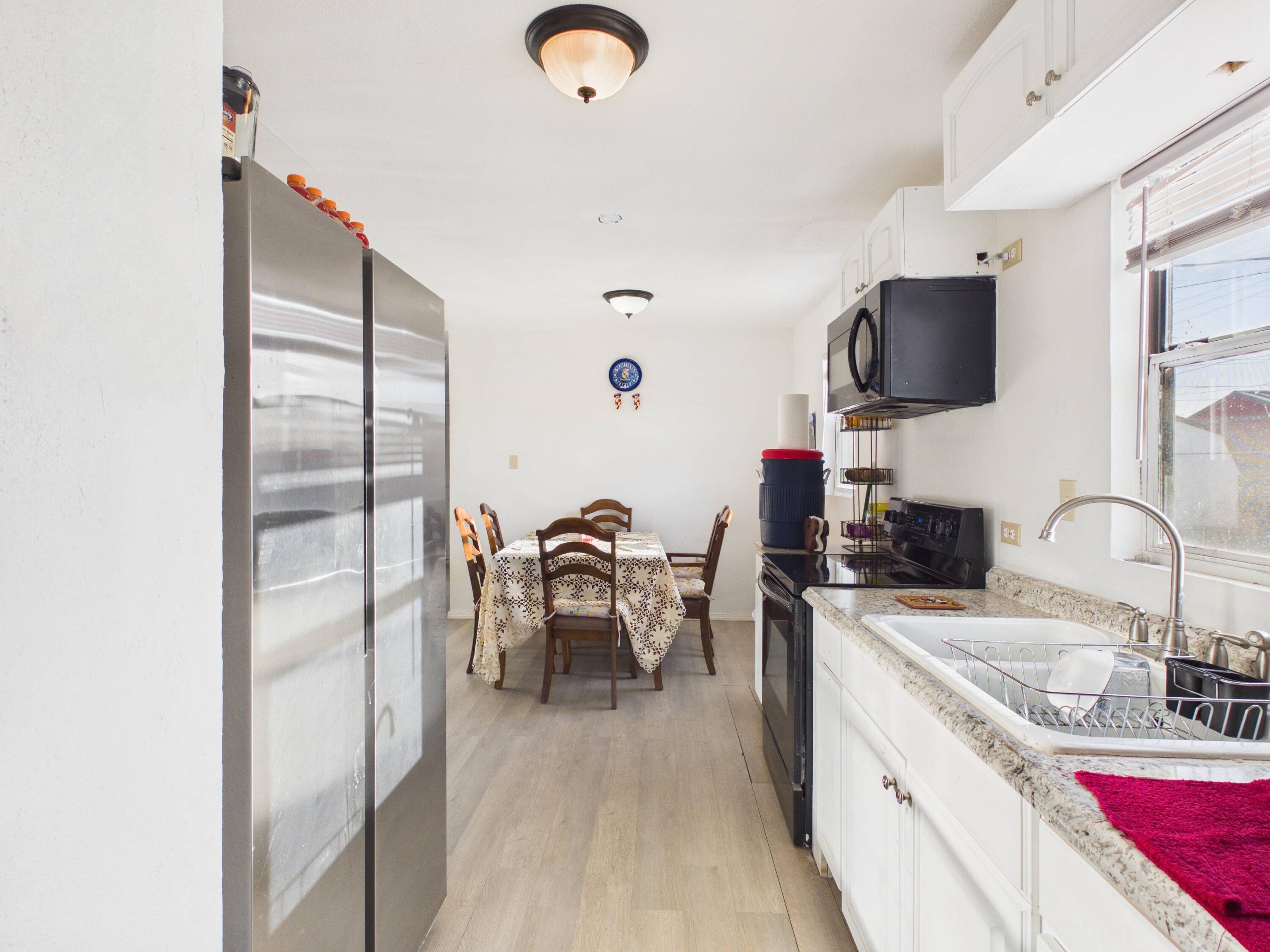 2804 Vanda Avenue Lubbock, TX 79404 - Photo 10 of 23 a kitchen with stainless steel appliances granite countertop a sink dishwasher a stove and a refrigerator