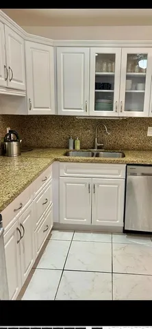 a view with granite countertop white cabinets and stainless steel appliances
