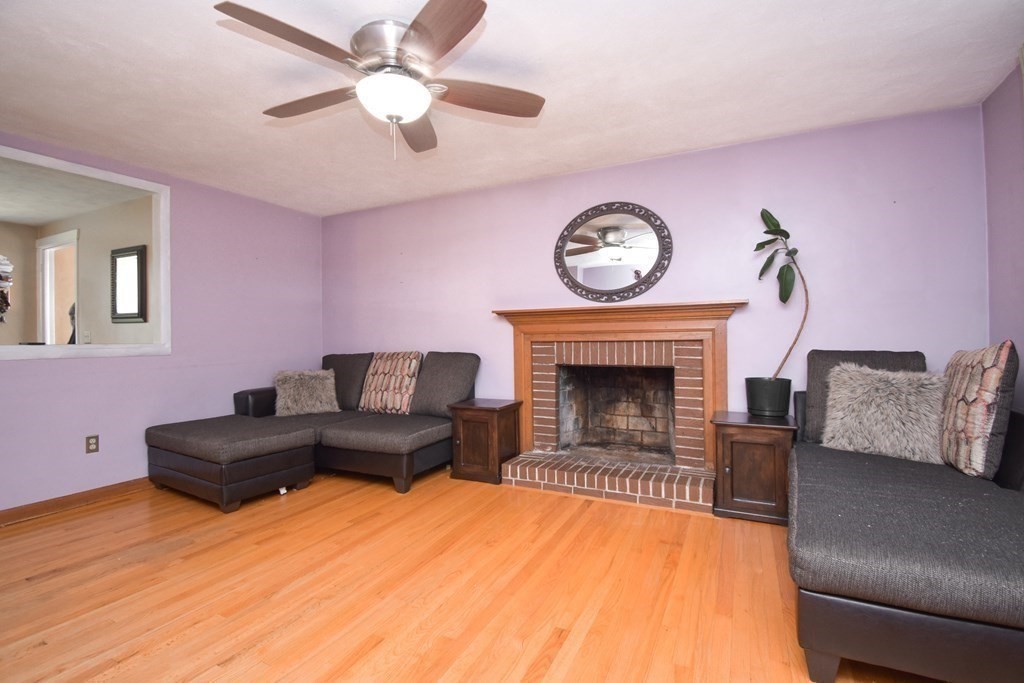 128 Tioga Street Springfield, MA 01128 - Photo 11 of 33 a living room with furniture and a fireplace