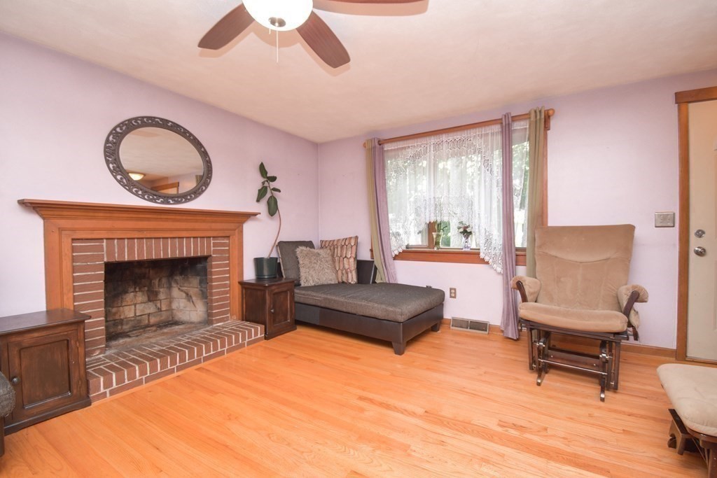 128 Tioga Street Springfield, MA 01128 - Photo 12 of 33 a living room with furniture and a fireplace