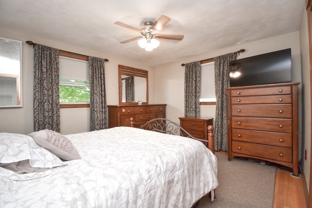128 Tioga Street Springfield, MA 01128 - Photo 15 of 33 a bedroom with a bed and a flat screen tv