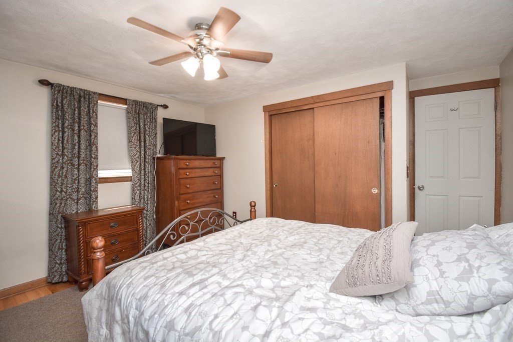 128 Tioga Street Springfield, MA 01128 - Photo 16 of 33 a bedroom with a large bed and a flat tv screen
