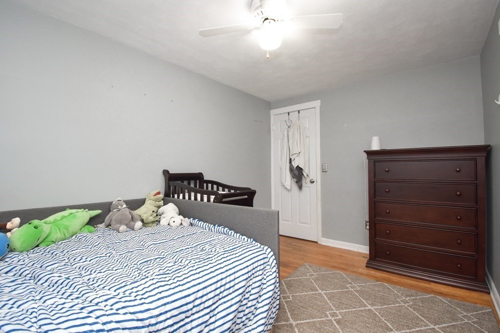 128 Tioga Street Springfield, MA 01128 - Photo 19 of 33 a bedroom with a bed and a cabinets