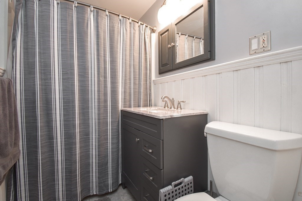 128 Tioga Street Springfield, MA 01128 - Photo 21 of 33 a bathroom with a shower curtain and a sink