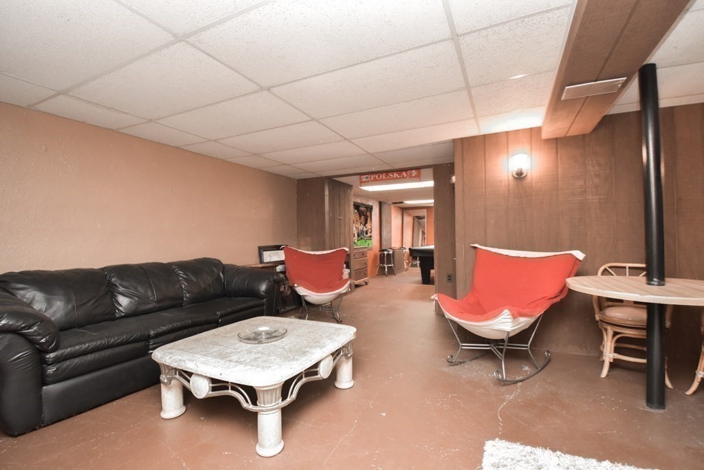 128 Tioga Street Springfield, MA 01128 - Photo 22 of 33 a living room with furniture a rug and a projector