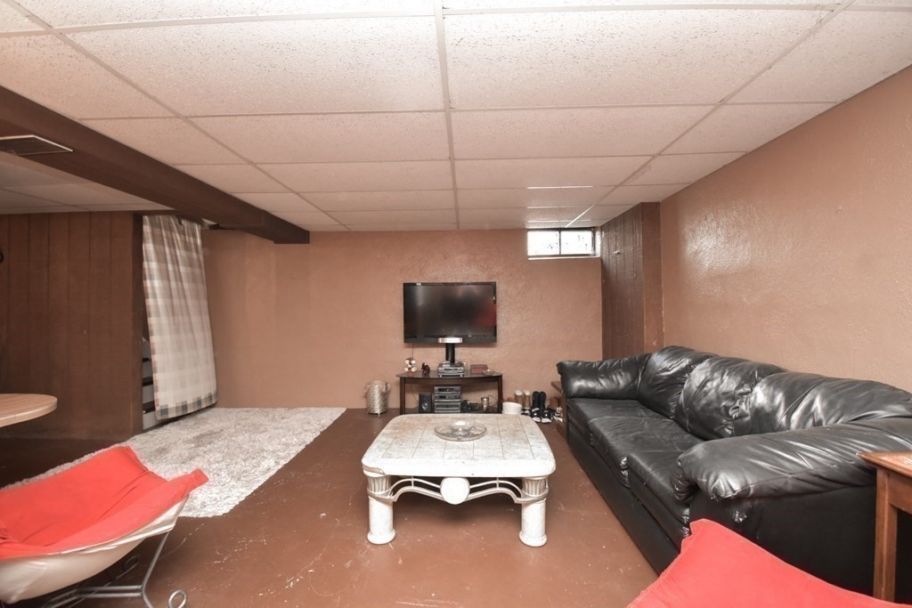 128 Tioga Street Springfield, MA 01128 - Photo 24 of 33 a living room with furniture and a flat screen tv
