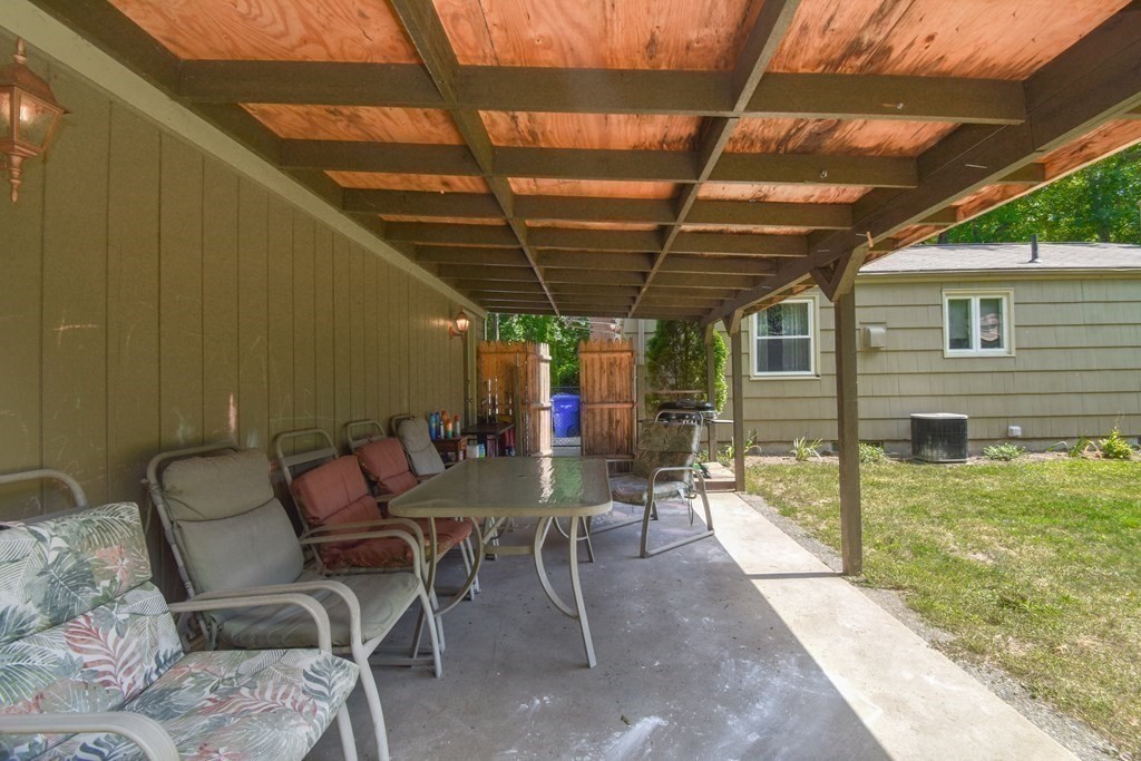 128 Tioga Street Springfield, MA 01128 - Photo 30 of 33 a view of a patio with table and chairs with wooden floor and fence