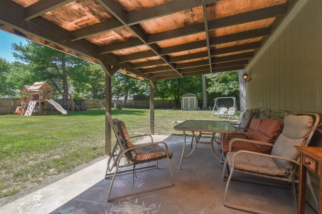 128 Tioga Street Springfield, MA 01128 - Photo 31 of 33 a view of a patio with a table chairs and a yard