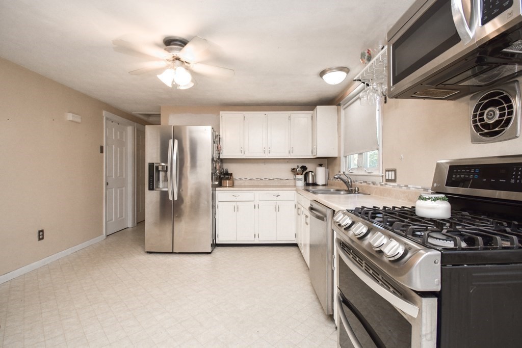 128 Tioga Street Springfield, MA 01128 - Photo 5 of 33 a kitchen with stainless steel appliances granite countertop a stove and a refrigerator