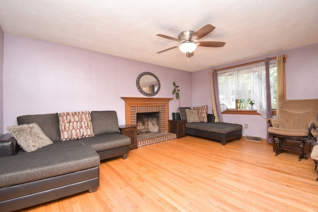 128 Tioga Street Springfield, MA 01128 - Photo 10 of 33 a living room with furniture and a fireplace