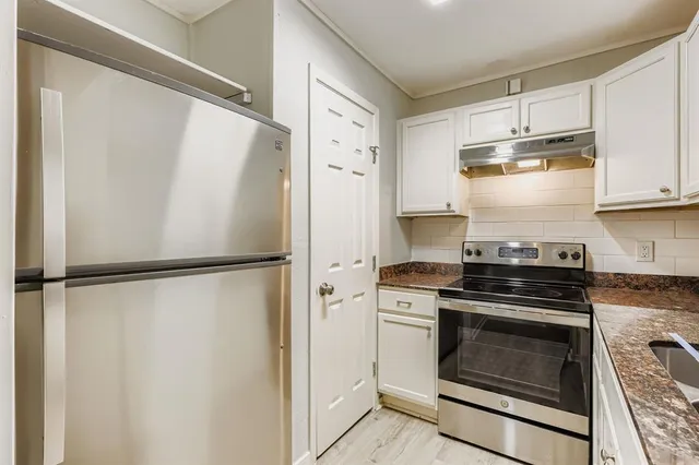 a kitchen with a stove and a refrigerator