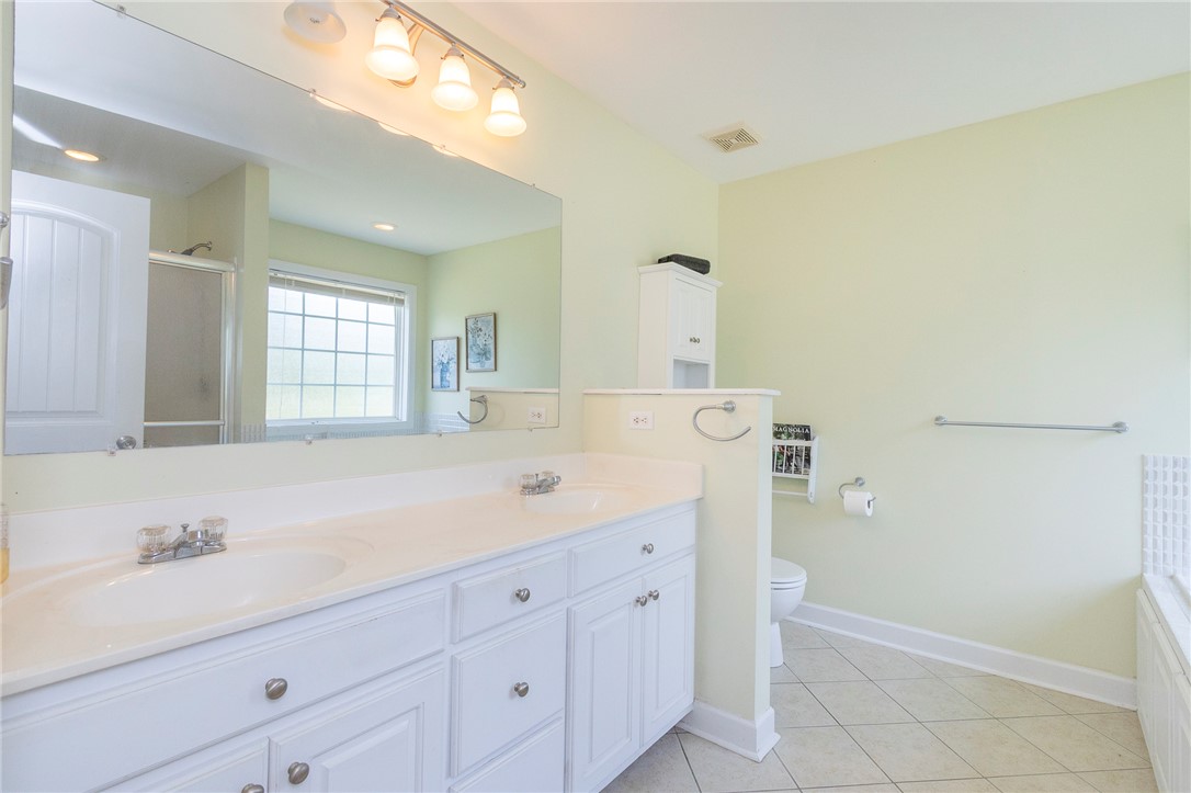 861 North Old Pendleton Road Liberty, SC 29657 - Photo 21 of 45 A well-lit bathroom features a spacious dual vanity and large window, reflecting a separate shower enclosure.