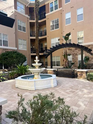 a view of a building with cars parked