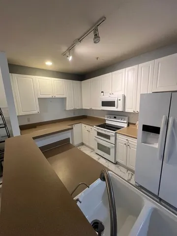 a kitchen with cabinets and stainless steel appliances
