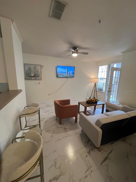 4221 West Spruce Street, Unit 2222 Tampa, FL 33607 - Photo 17 of 25 a living room with furniture and a flat screen tv