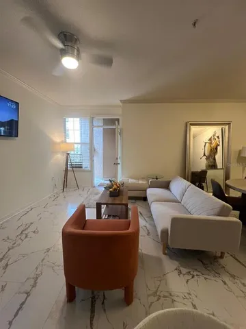 a living room with furniture and a lamp