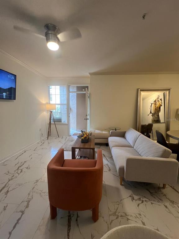 4221 West Spruce Street, Unit 2222 Tampa, FL 33607 - Photo 20 of 25 a living room with a couch and a potted plant