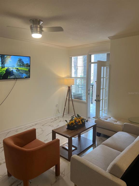 4221 West Spruce Street, Unit 2222 Tampa, FL 33607 - Photo 21 of 25 a living room with furniture and a window