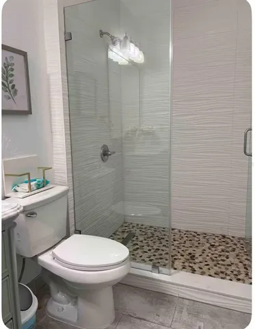 a bathroom with a toilet and shower
