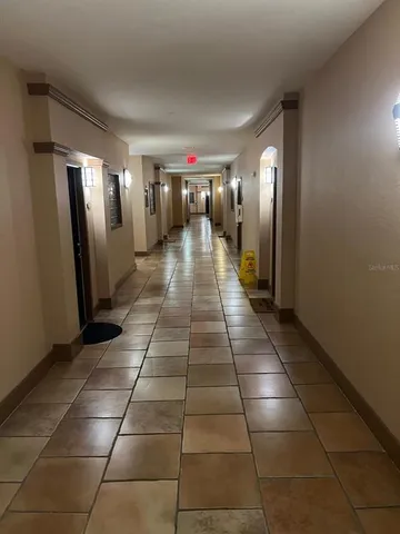 a view of a hallway with seating area