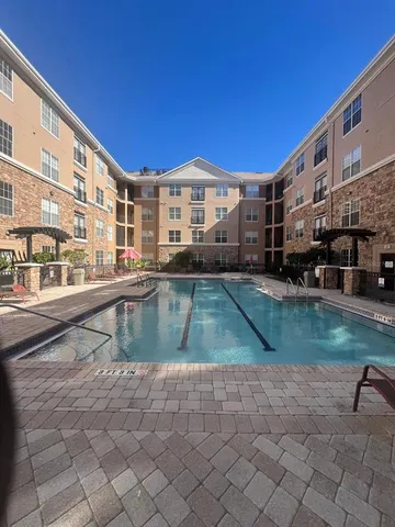 a view of pool with outdoor seating