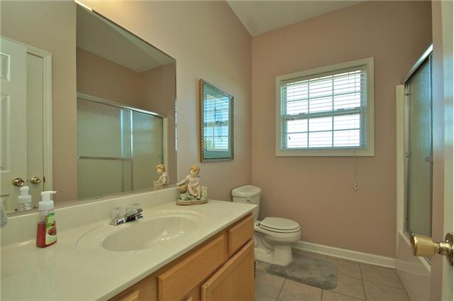 3944 Flewellyn Road Springfield, TN 37172 - Photo 15 of 20 a bathroom with a granite countertop sink a toilet and a mirror