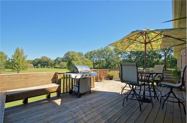 3944 Flewellyn Road Springfield, TN 37172 - Photo 18 of 20 a view of a roof deck with table and chairs under an umbrella