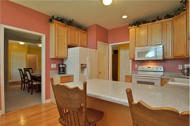 3944 Flewellyn Road Springfield, TN 37172 - Photo 6 of 20 a kitchen with stainless steel appliances refrigerator dining table and chairs