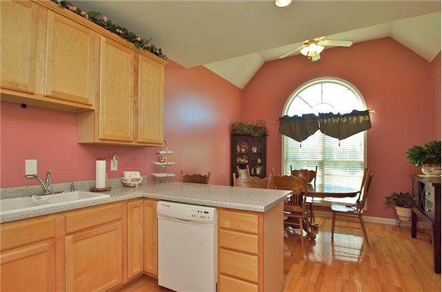 3944 Flewellyn Road Springfield, TN 37172 - Photo 7 of 20 a kitchen with a sink cabinets and dining table