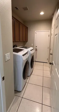 a view of an empty room with wooden floor and a ceiling fan