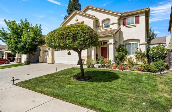 a front view of a house with garden