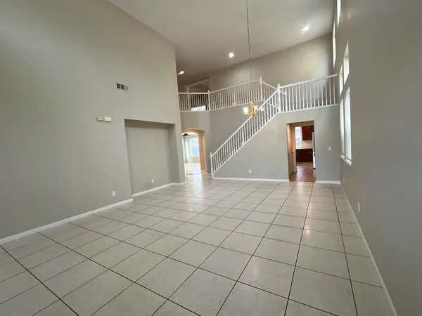 a view of an entryway with an empty space and windows