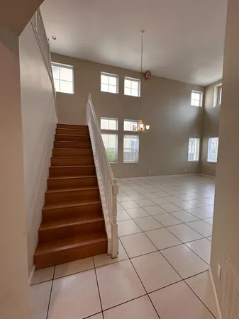 a lobby with entryway and a chandelier