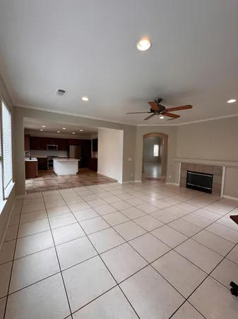 an empty room with windows and chandelier