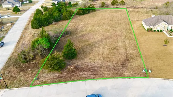 a backyard of a house with a yard and outdoor seating