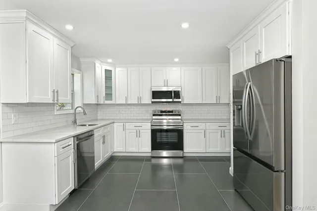 a kitchen with a refrigerator sink and microwave