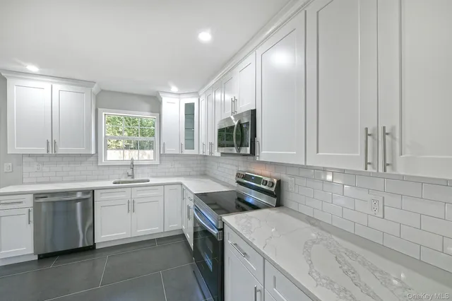 a kitchen with a sink stove and cabinets