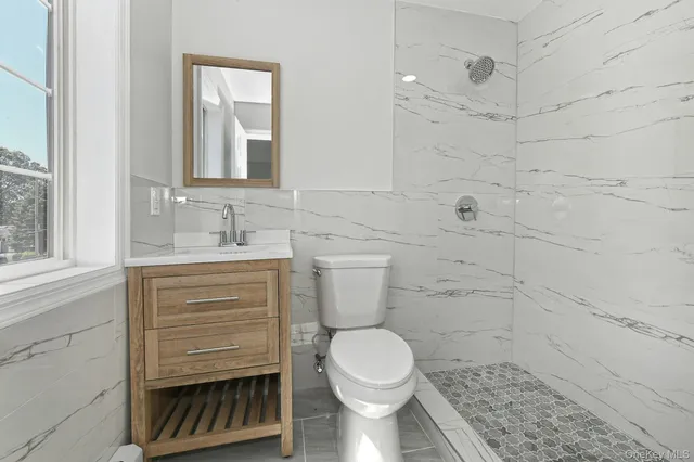 an empty room with closet and entrance