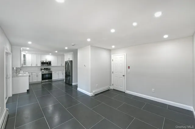 a bathroom with a sink toilet vanity and bathtub