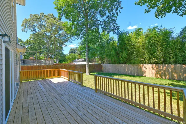 a view of a wooden deck in backyard