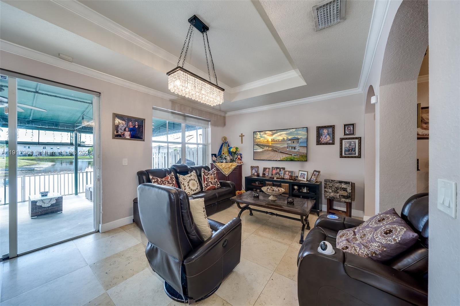 15242 Southwest 8th Way Miami, FL 33194 - Photo 12 of 62 a living room with furniture and a chandelier