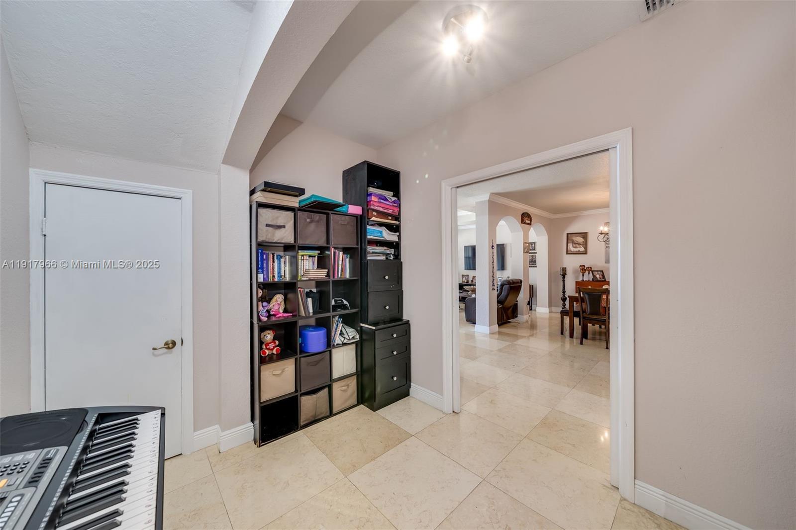 15242 Southwest 8th Way Miami, FL 33194 - Photo 15 of 62 a living room with lots of books and a book shelf