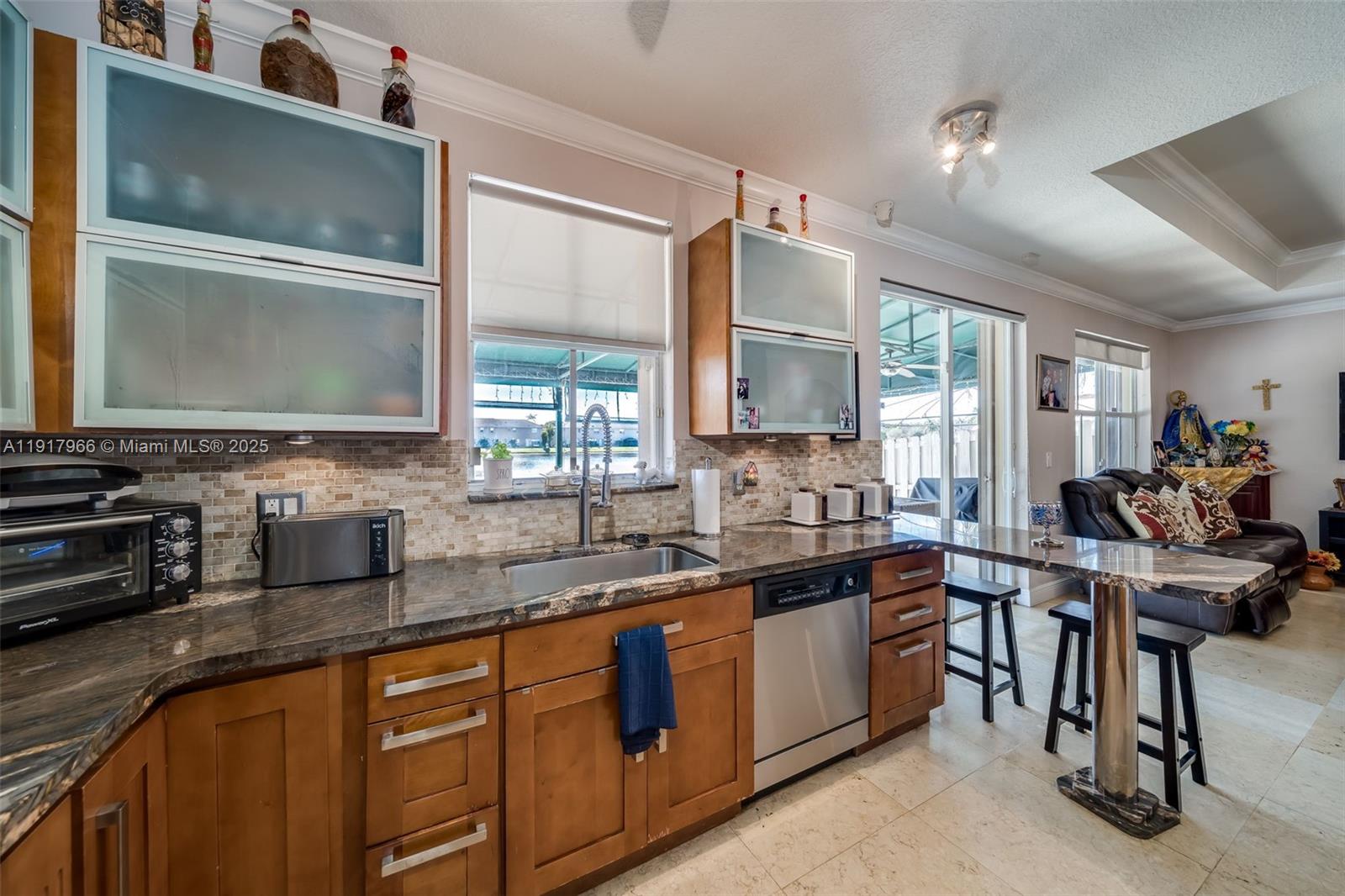 15242 Southwest 8th Way Miami, FL 33194 - Photo 19 of 62 a kitchen with stainless steel appliances granite countertop a sink a stove counter space and cabinets