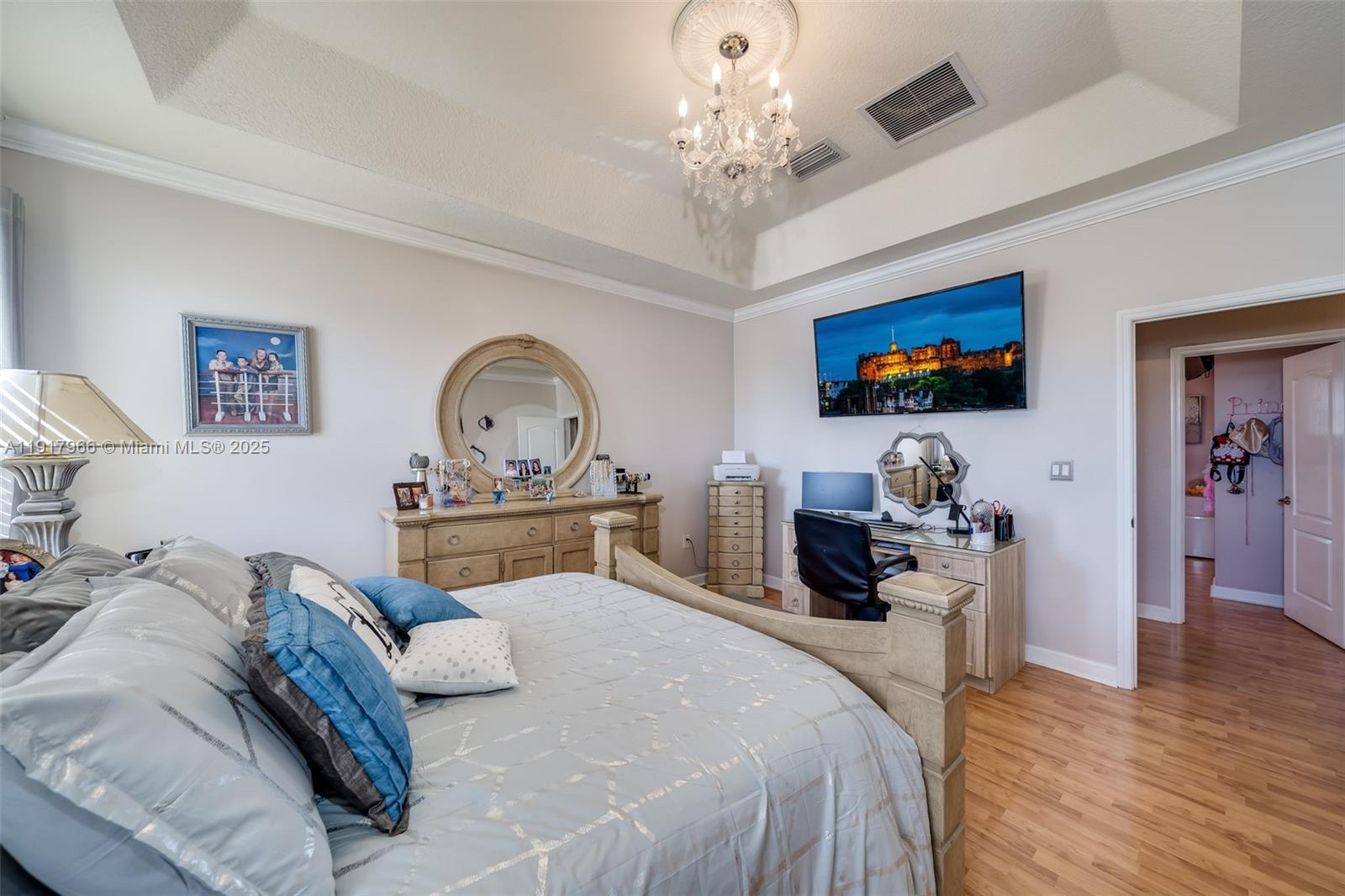 15242 Southwest 8th Way Miami, FL 33194 - Photo 22 of 62 a bedroom with a bed and a chandelier