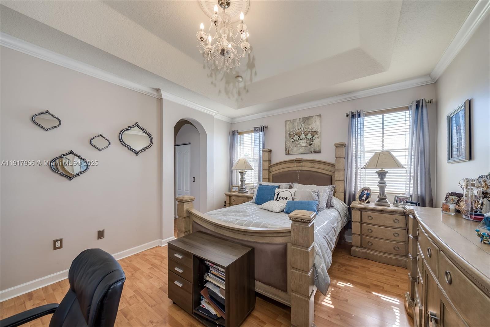 15242 Southwest 8th Way Miami, FL 33194 - Photo 24 of 62 a bedroom with a bed and a chandelier