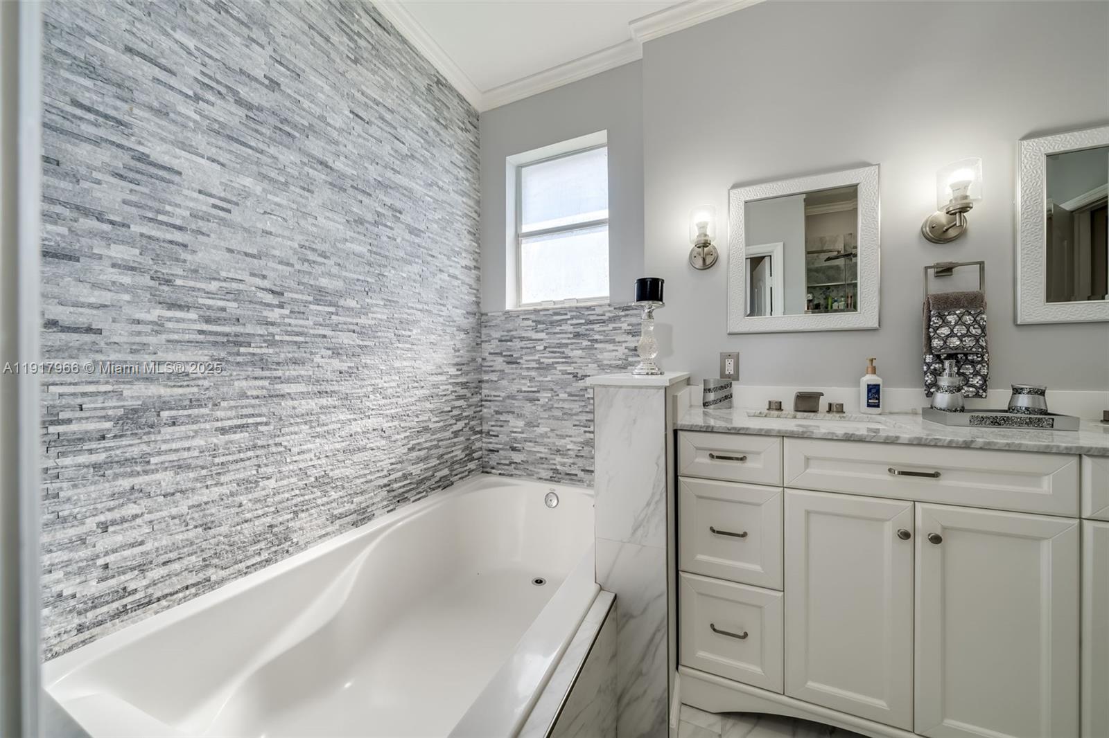 15242 Southwest 8th Way Miami, FL 33194 - Photo 26 of 62 a bathroom with a granite countertop sink mirror and a bathtub
